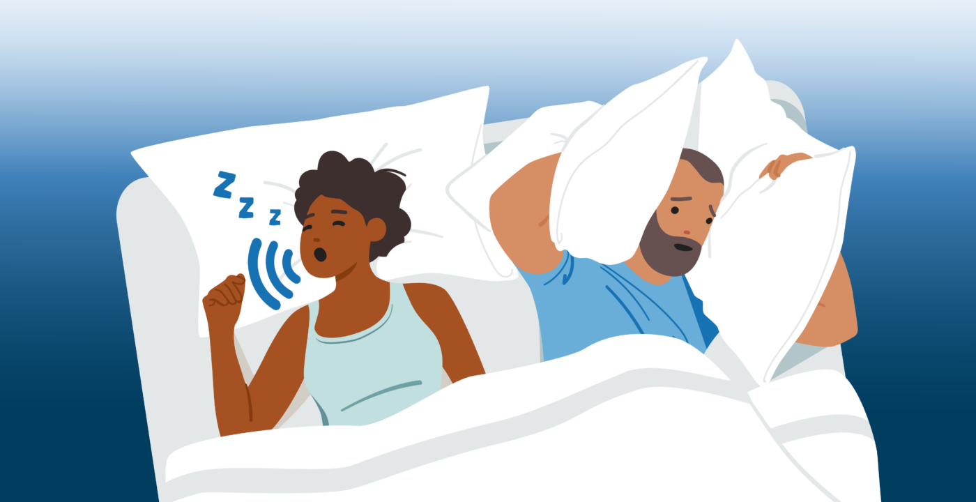 Man covers ears with a pillow as woman snores next to him