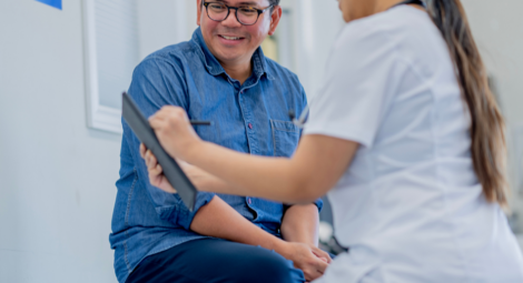 Male patient and female doctor review test results