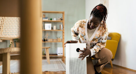 Woman presses button on air purifier