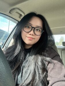 Woman in car taking a photo.