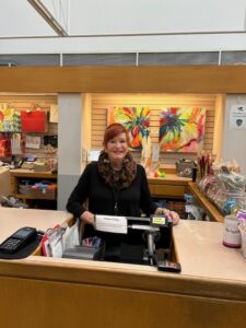 Woman smiling at a desk.