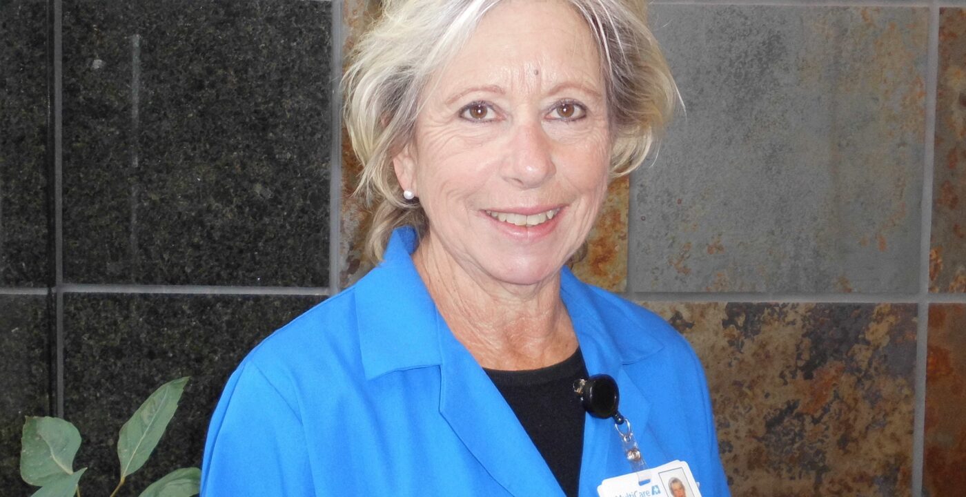 Woman in blue polo with badge