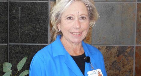 Woman in blue polo with badge