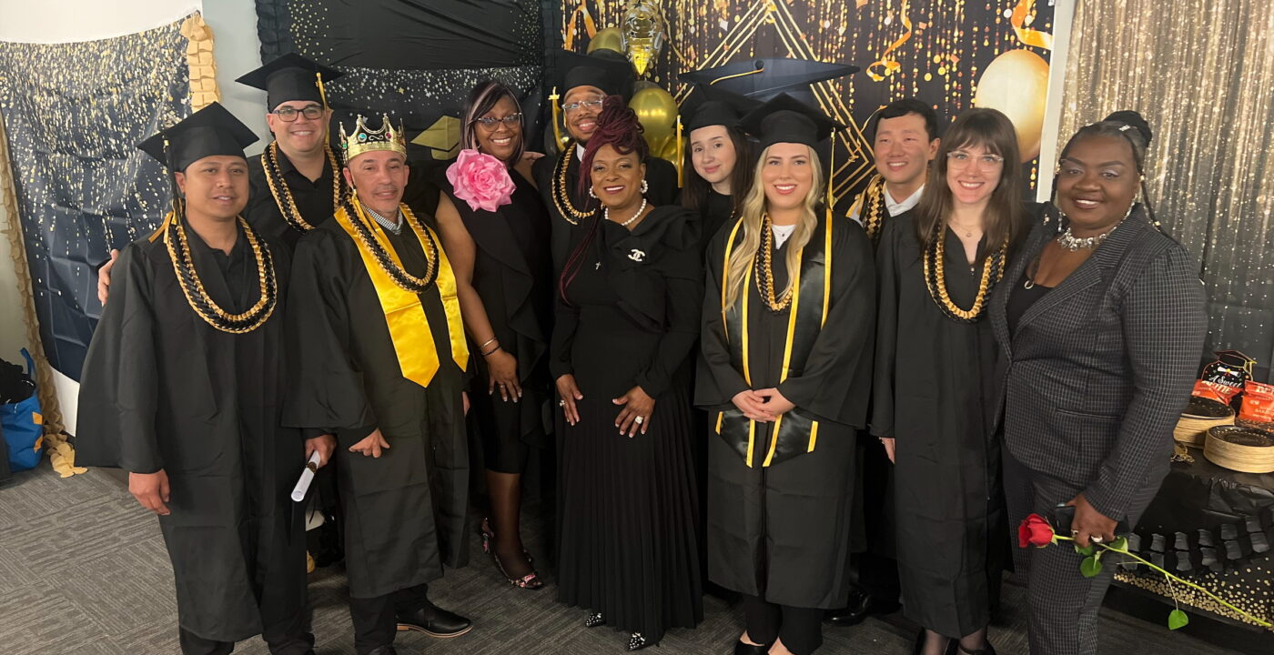 Group of people wearing graduation caps and gowns standing together