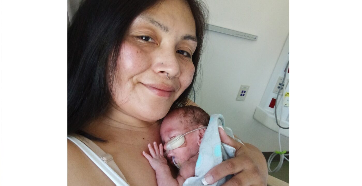 Close-up of mom holding newborn in hospital