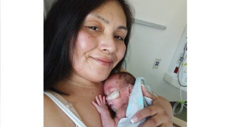 Close-up of mom holding newborn in hospital