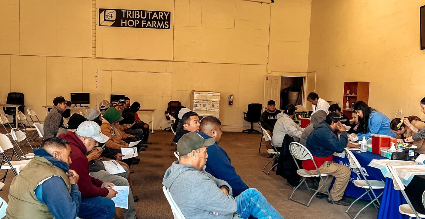 People sit on chairs inside warehouse