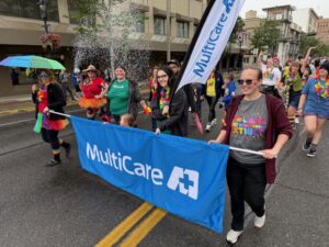 People hold banner and walk in parade