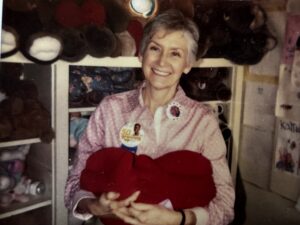 Woman holding felt heart.