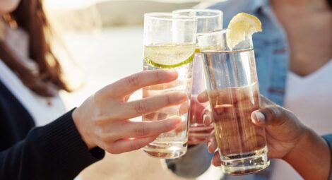 People clinking drink glasses