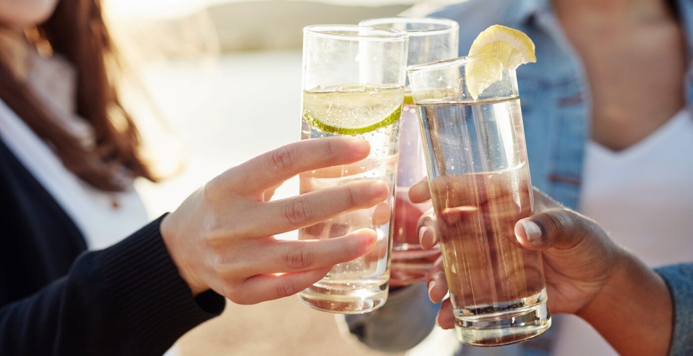 People clinking drink glasses