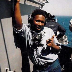 Guy smiling next to a boat