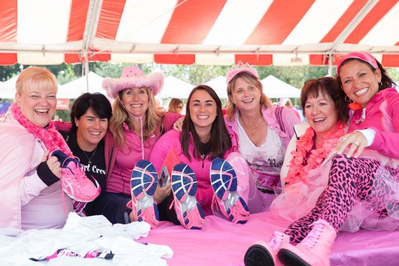 Group of smiling and laughing women in pink