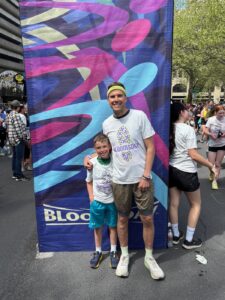 man and young boy pose, Woelber ran his first Bloomsday post-injury less than two years after surgery