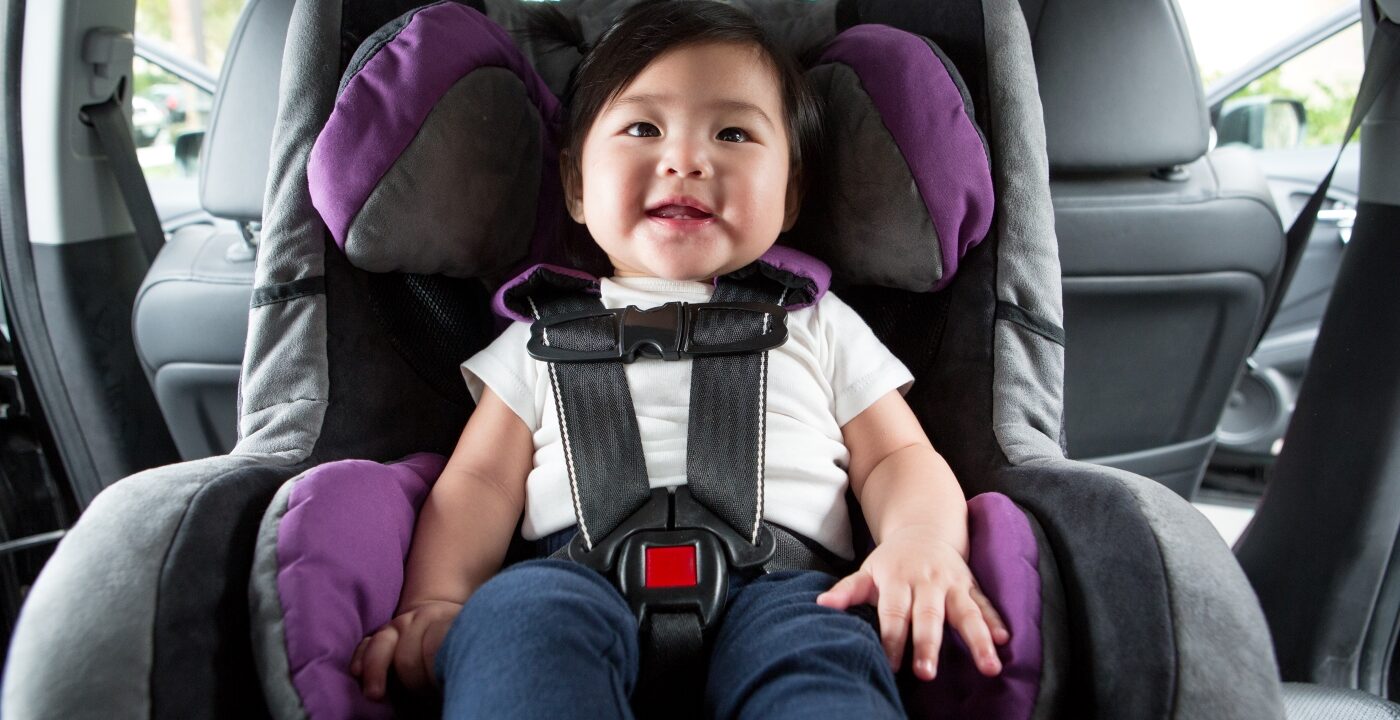 Baby strapped into a car seat