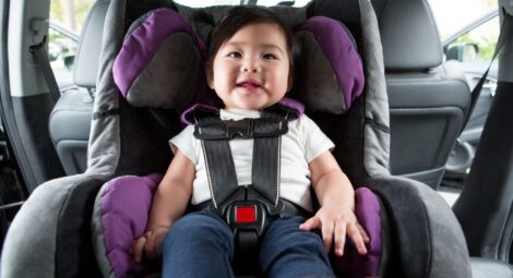 Baby strapped into a car seat