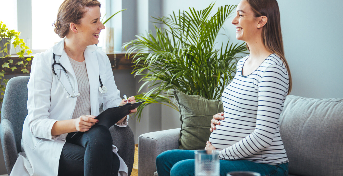 Pregnant woman talking to provider