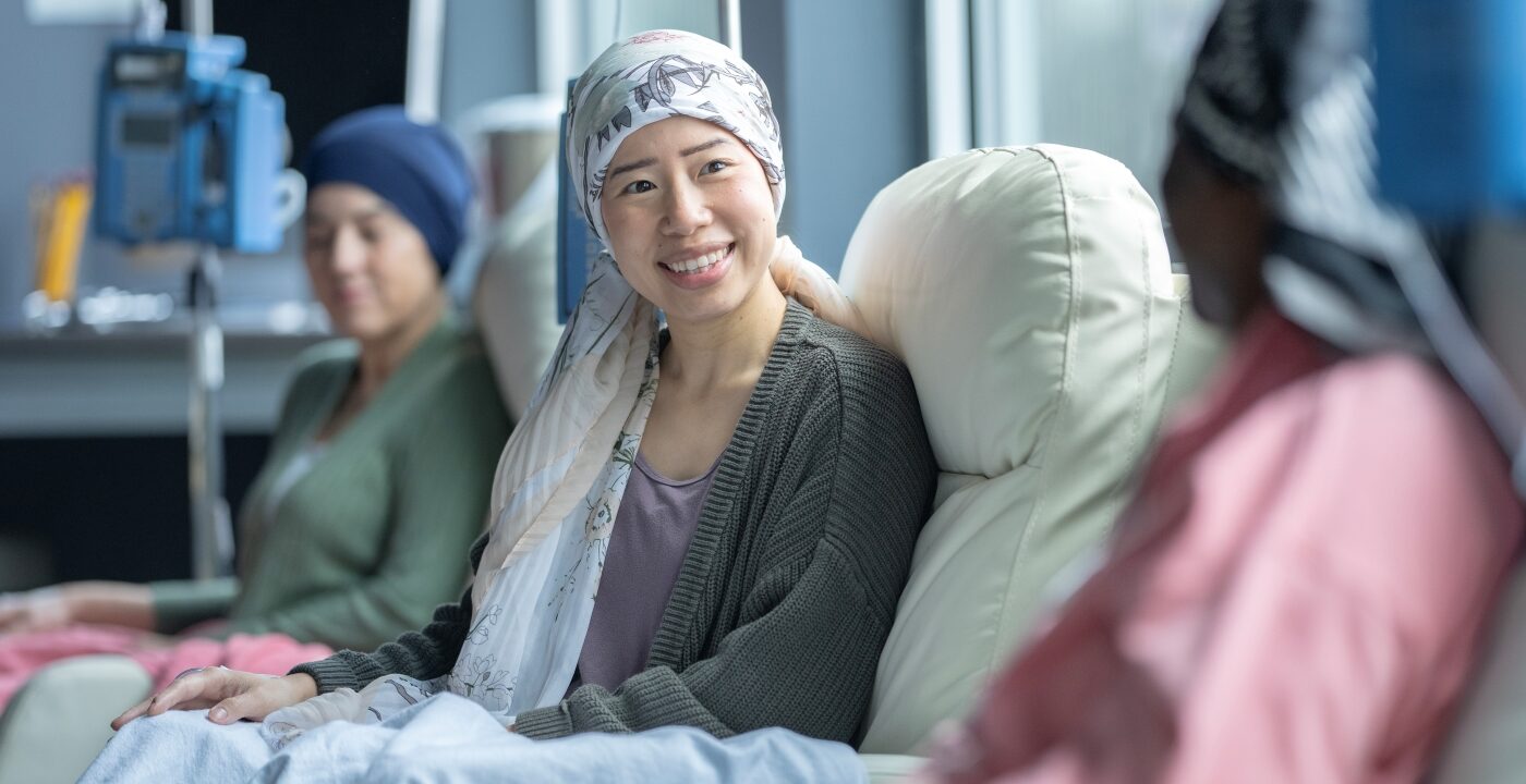 Woman sits in hospital treatment chair