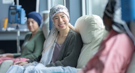 Woman sits in hospital treatment chair
