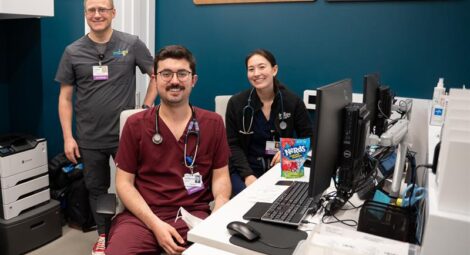 Three people in scrubs pose for photo