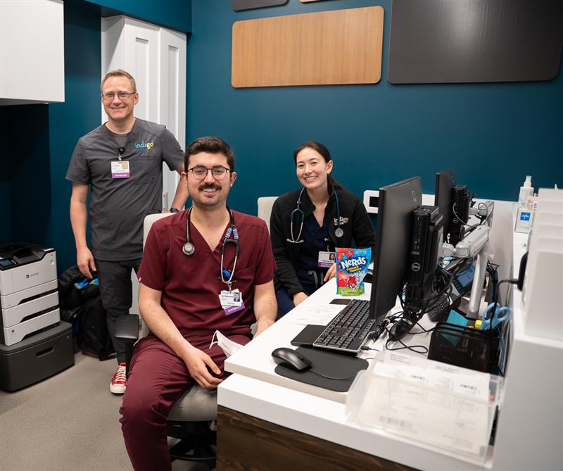 Three people in scrubs pose for photo