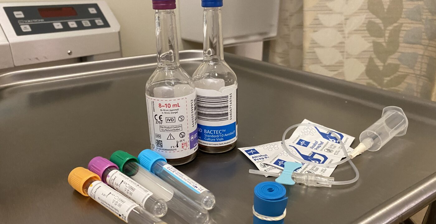 Tools and vials to collect blood sit on table