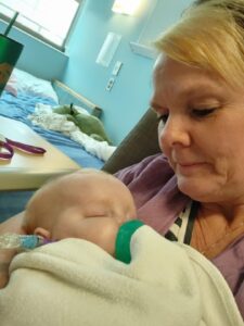 A woman holding a baby