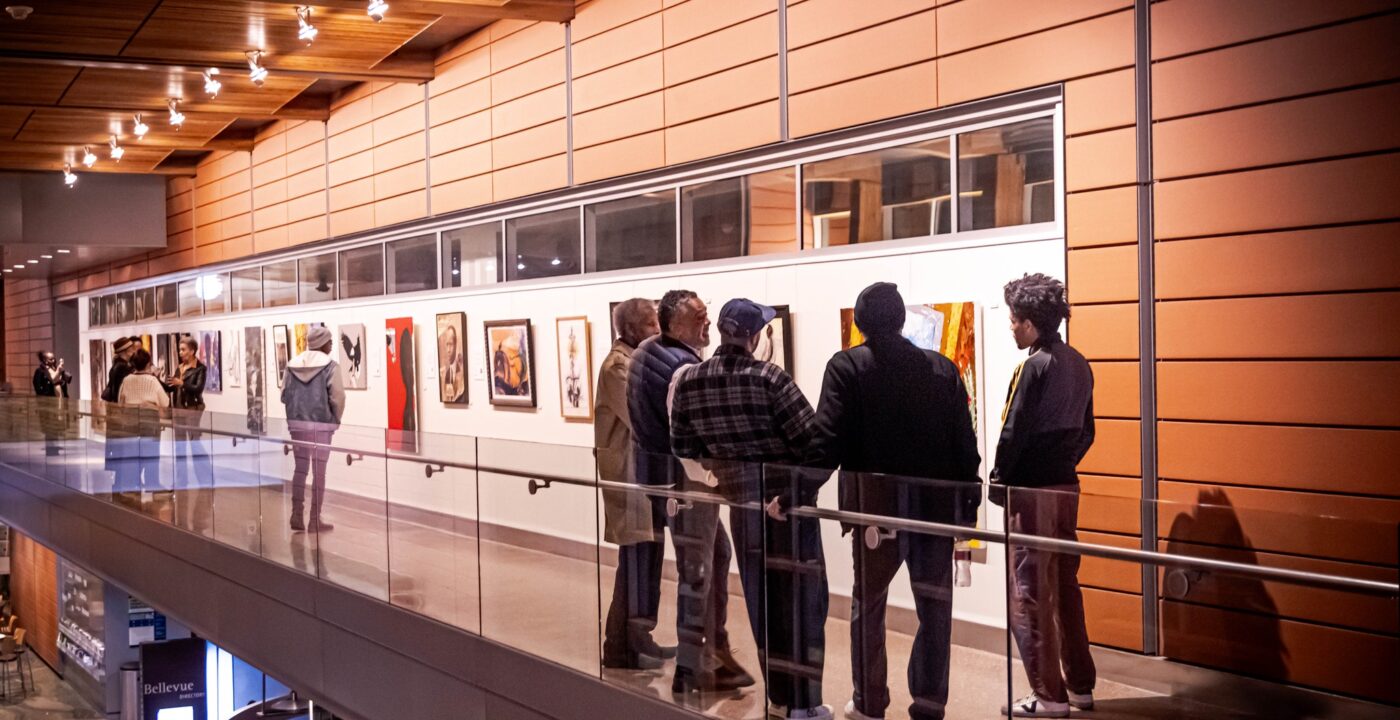 People stand in art gallery