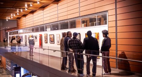 People stand in art gallery