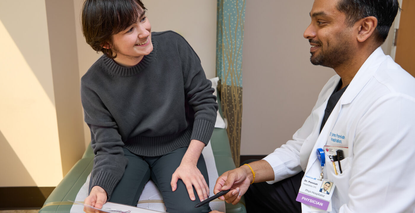 Patient and doctor sit and talk in clinic room