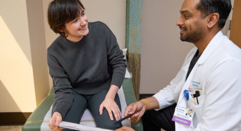 Patient and doctor sit and talk in clinic room