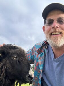 man with black sheep
