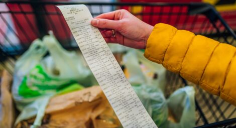 Grocery shopper looking at long receipt