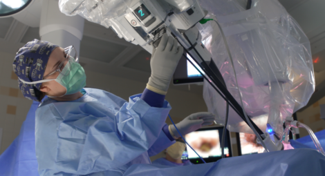 Video still of a surgeon performing robotic surgery