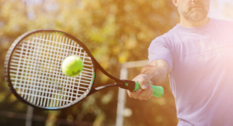 man hitting ball with tennis racket