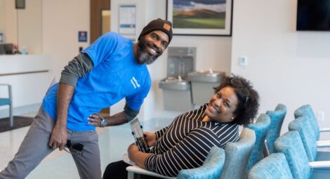 An employee and a patient in an emergency room waiting area