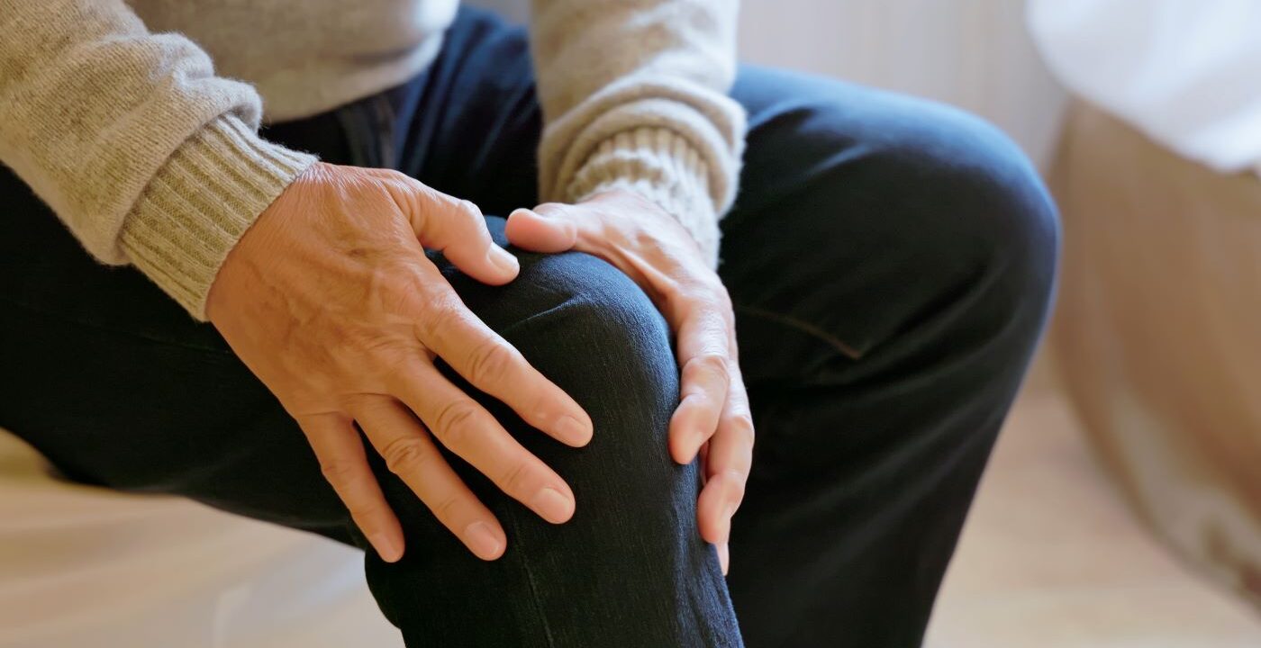 Close up of a man holding his knee
