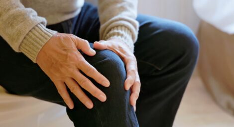 Close up of a man holding his knee