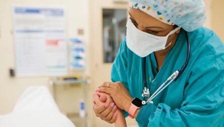 Nurse holding patient's hand