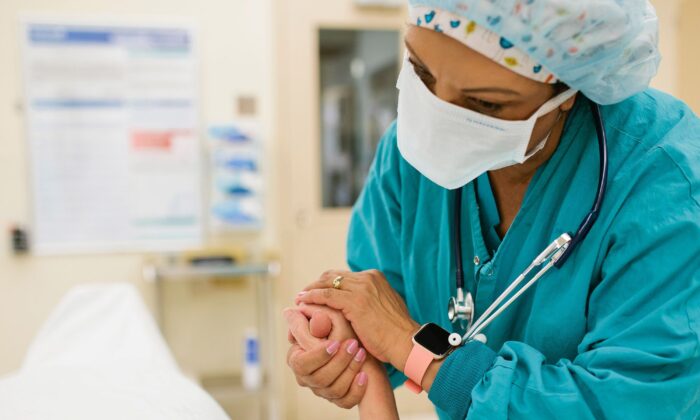 Nurse holding patient's hand