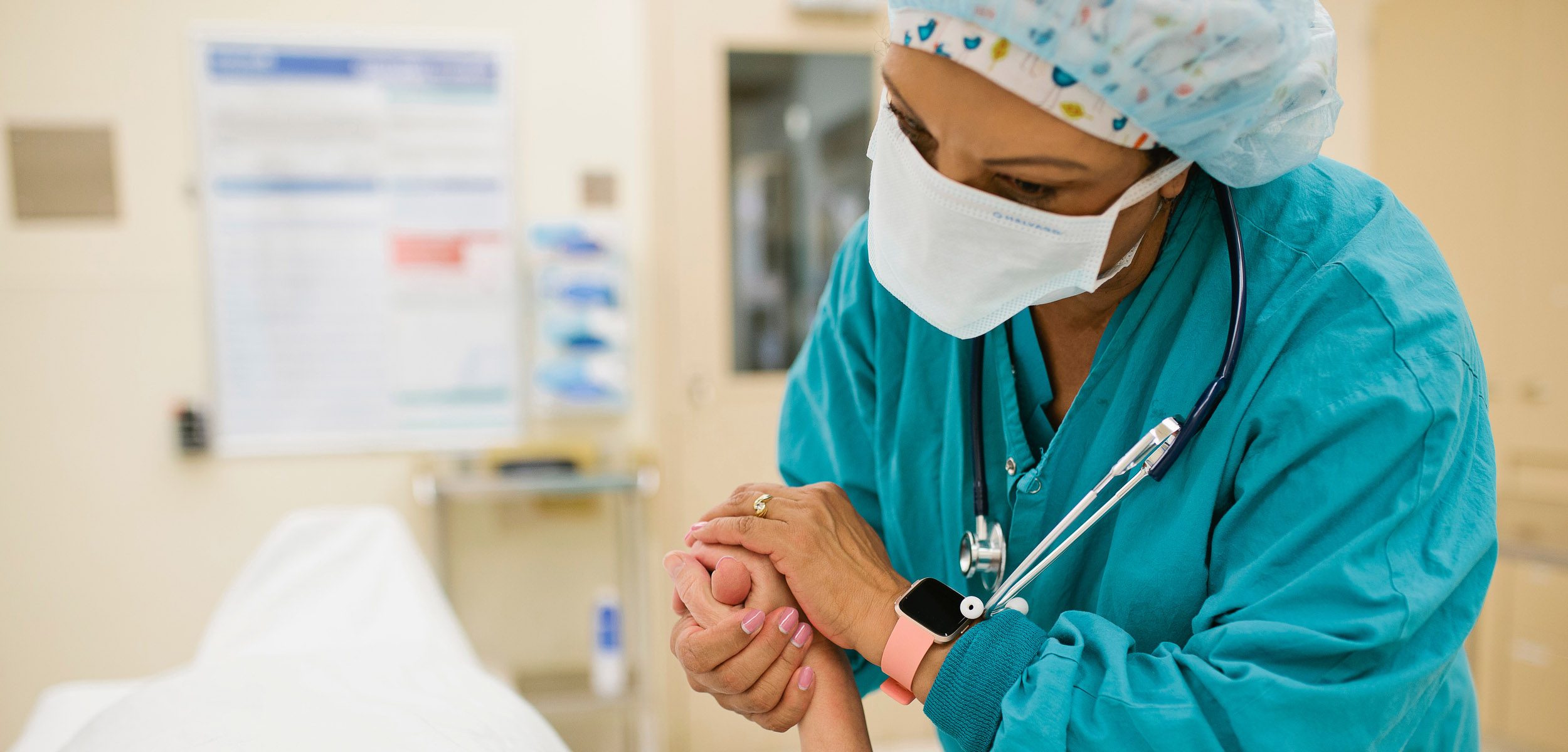 Nurse holding patient's hand