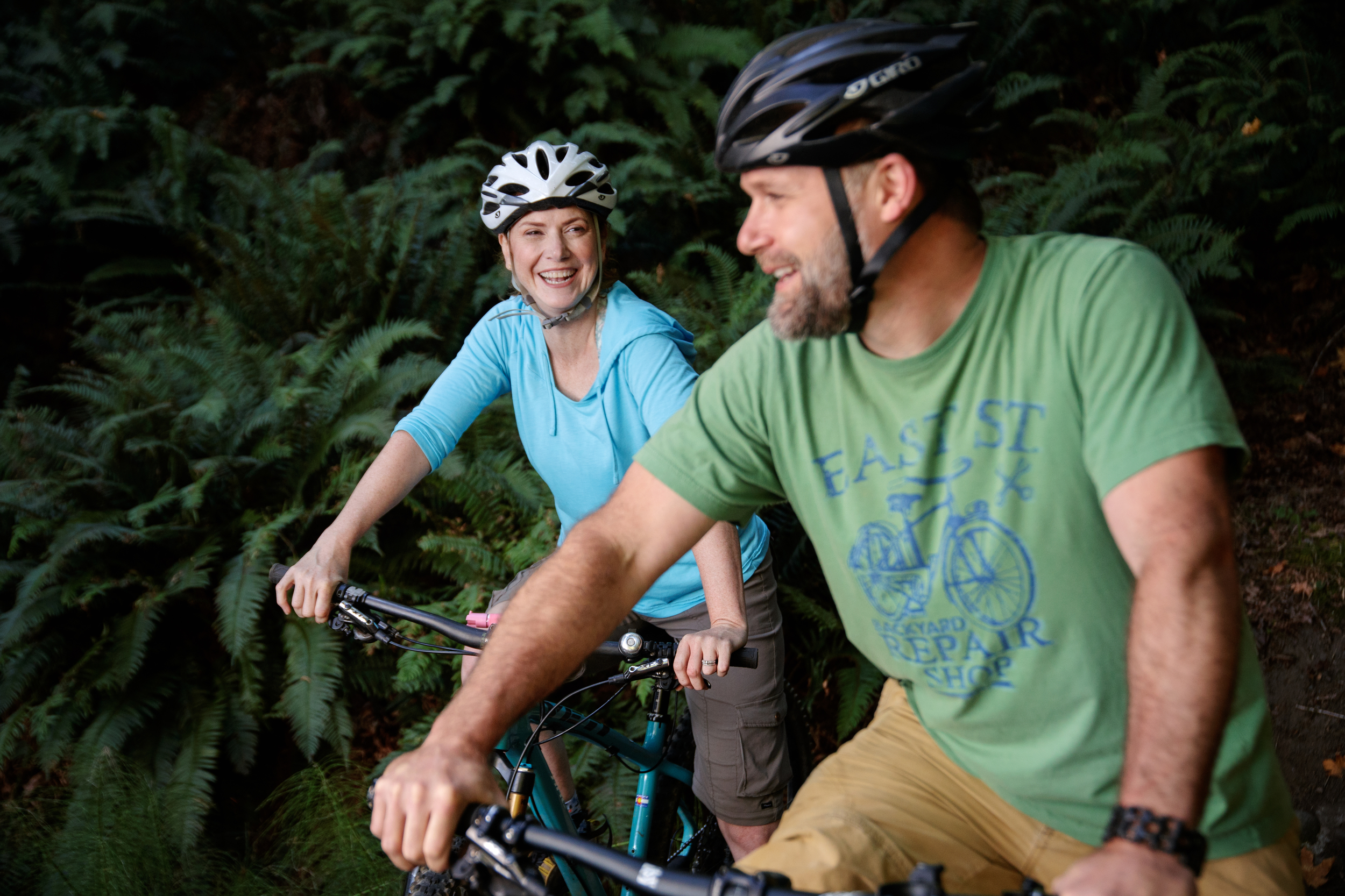 Couple smiling on bikes