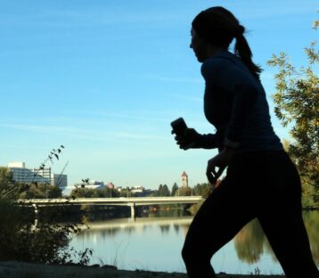 Woman running by a river
