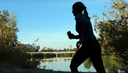 Woman running by a river