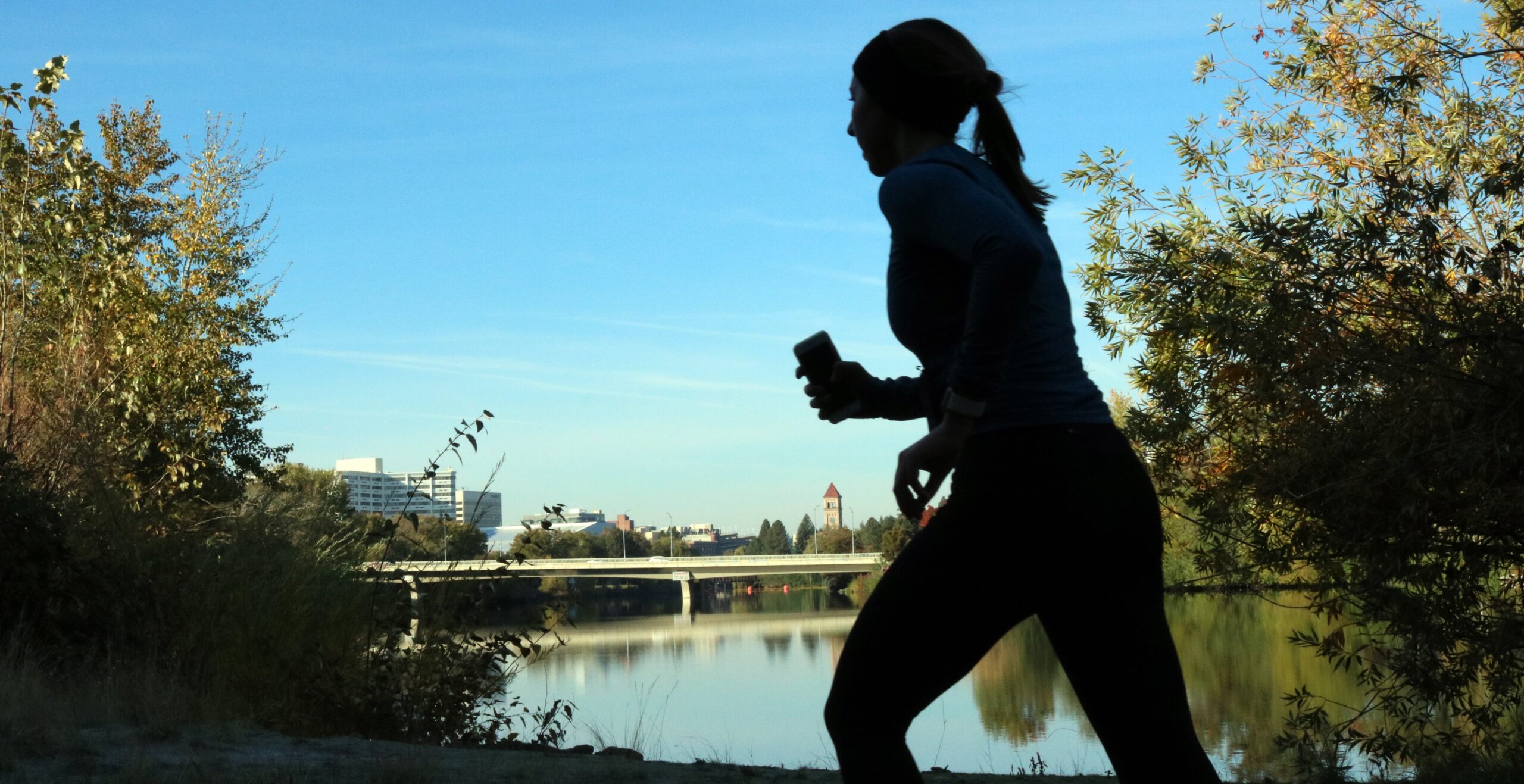 Woman running by a river