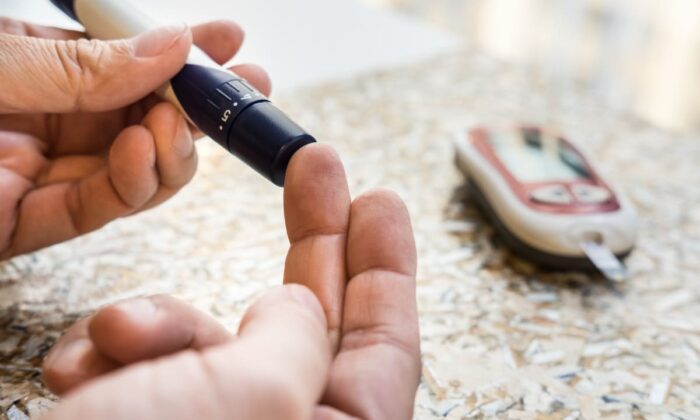 Man checking blood sugar
