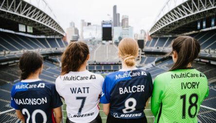 Four women in sports jerseys