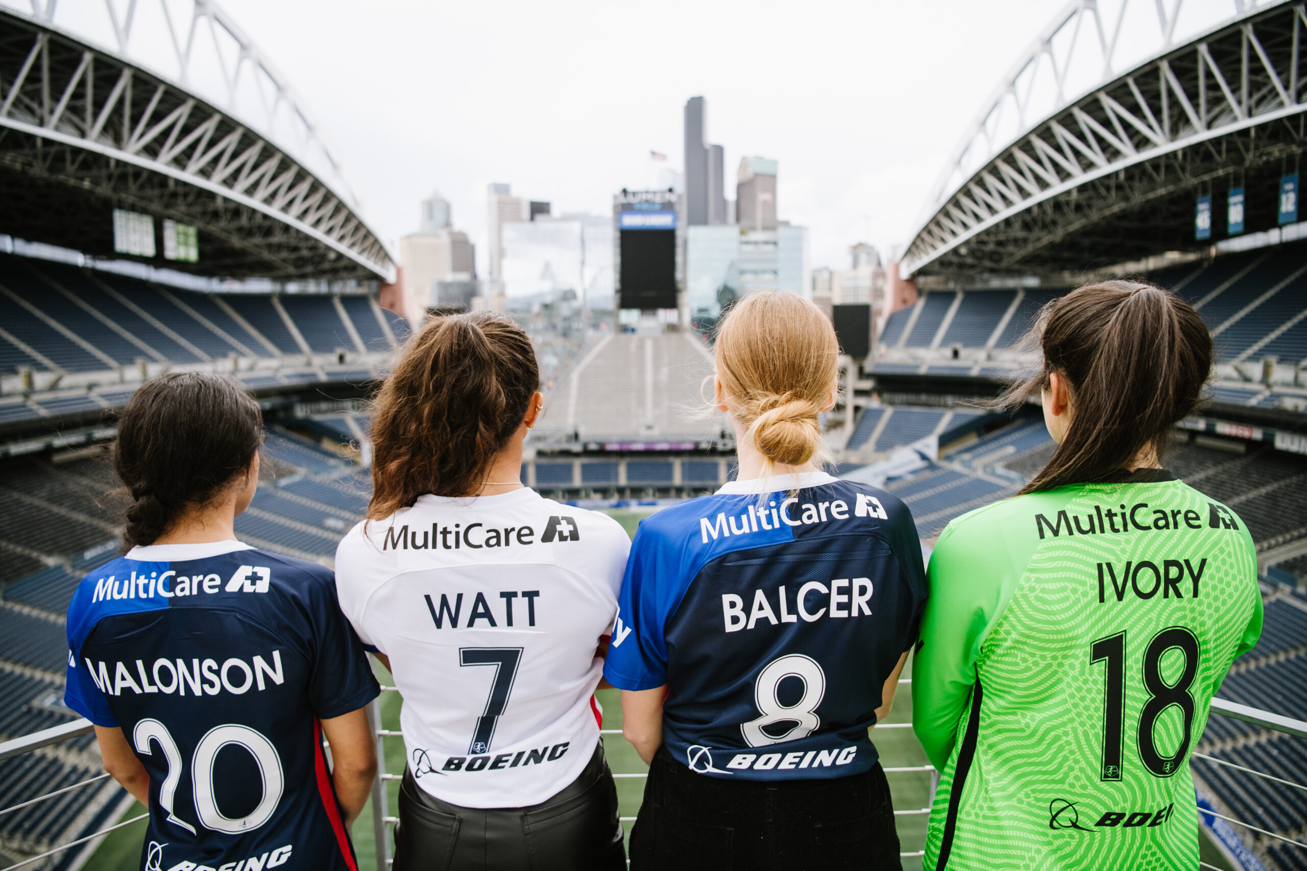 Four women in sports jerseys