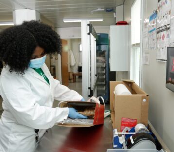 Medical personnel opening drone-delivered package.