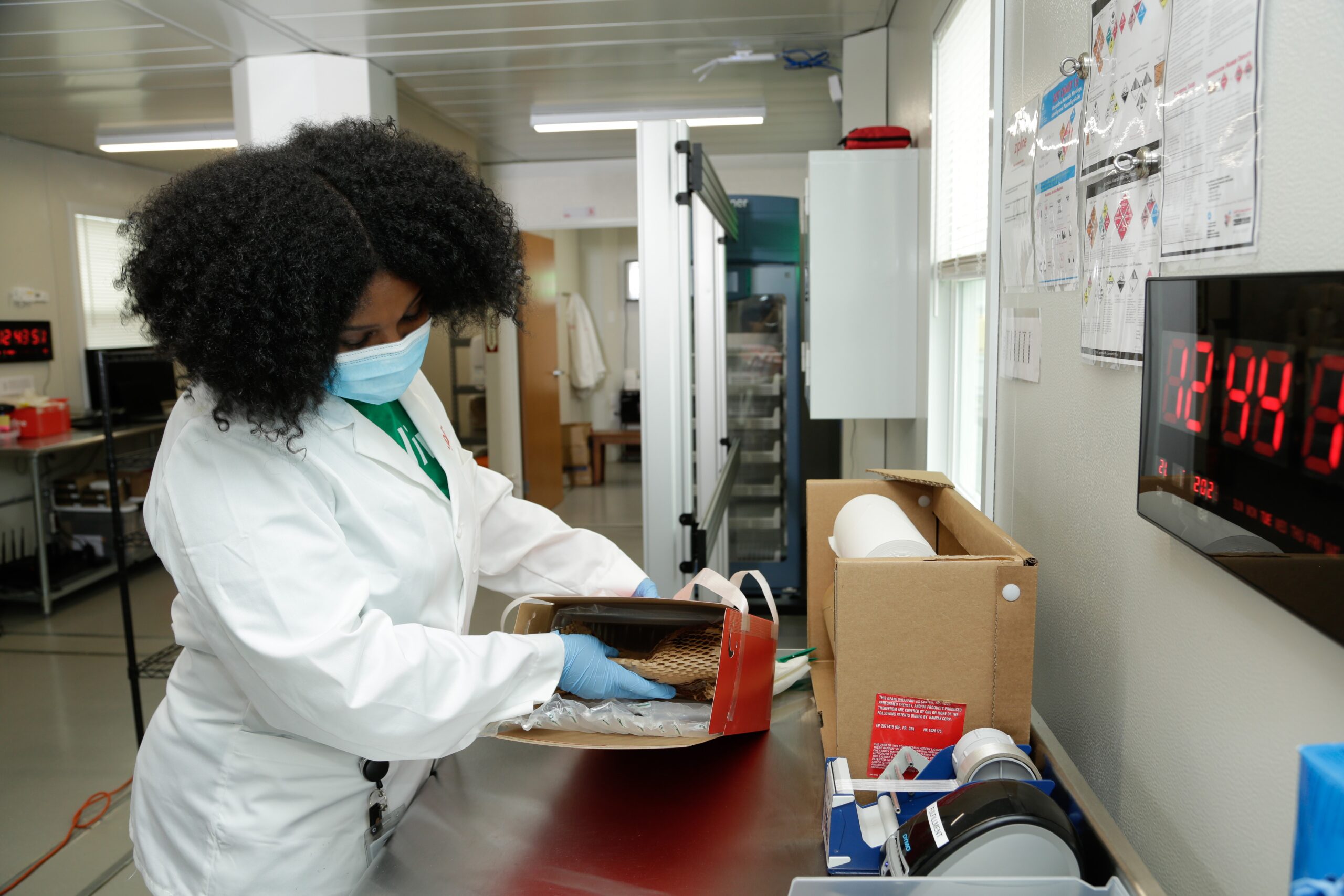 Medical personnel opening drone-delivered package.